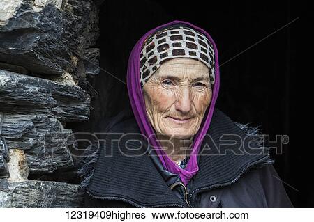 Stock Photograph - Old Svan woman at the Eth0graphic Museum in Zhibiani village; Ushguli, Samegrelo-Zemo Svaneti, Georgia. Fotosearch