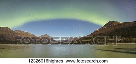 Panorama of a single band of green Aurora Borealis lights up the night on a clear night at Upper Trail Lake in Moose Pass, South-central Alaska; Alaska, United States of America View Large Photo Image Stock Photograph - Panorama of a single band of green Aurora Borealis lights up the night on a clear night at Upper Trail Lake in Moose Pass, South-central Alaska; Alaska, United States of America. Fotosearch