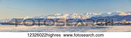 Panorama of downtown Anchorage and the port of Anchorage in winter, snow capped Chugach Mountains in the background, seen from Point MacKenzie, the skies in the background clear and bright, sea ice covering Cook Inlet in the foreground, South-central... View Large Photo Image Stock Photograph - Panorama of downtown Anchorage and the port of Anchorage in winter, snow capped Chugach Mountains in the background, seen from Point MacKenzie, the skies in the background clear and bright, sea ice covering Cook Inlet in the foreground, South-central.... Fotosearch