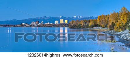 Panorama of high tide on Cook Inlet shows the reflections of downtown Anchorage buildings just after sunset, the Chugach Mountains in the background, South-central Alaska; Anchorage, Alaska, United States of America View Large Photo Image Stock Photograph - Panorama of high tide on Cook Inlet shows the reflections of downtown Anchorage buildings just after sunset, the Chugach Mountains in the background, South-central Alaska; Anchorage, Alaska, United States of America. Fotosearch