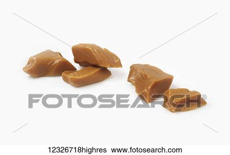 Pieces of caramel on a white background View Large Photo Image Stock Photograph - Pieces of caramel on a white background. Fotosearch