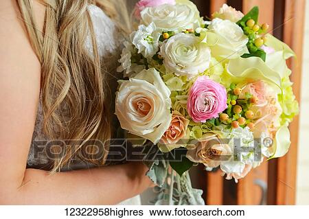 Portrait of a bride with long, blond hair and a flower bouquet; Oregon, United States of America View Large Photo Image Stock Photograph - Portrait of a bride with long, blond hair and a flower bouquet; Oregon, United States of America. Fotosearch