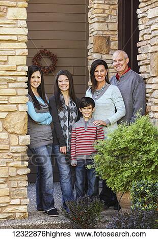 Portrait of a family with three children standing at the door of their house; Oregon, United States of America View Large Photo Image Stock Photograph - Portrait of a family with three children standing at the door of their house; Oregon, United States of America. Fotosearch