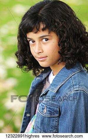 Portrait of a girl with dark, curly hair; Oregon, United States of America View Large Photo Image Stock Photograph - Portrait of a girl with dark, curly hair; Oregon, United States of America. Fotosearch