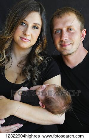 Portrait of a husband and wife with their infant son; Oregon, United States of America View Large Photo Image Stock Photograph - Portrait of a husband and wife with their infant son; Oregon, United States of America. Fotosearch