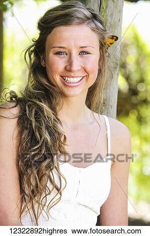 Portrait of a teenage girl with long curly hair; Oregon, United States of America View Large Photo Image Stock Photograph - Portrait of a teenage girl with long curly hair; Oregon, United States of America. Fotosearch