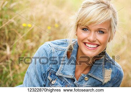 Portrait of a woman sitting in a field of tall grass; Oregon, United States of America View Large Photo Image Stock Photograph - Portrait of a woman sitting in a field of tall grass; Oregon, United States of America. Fotosearch