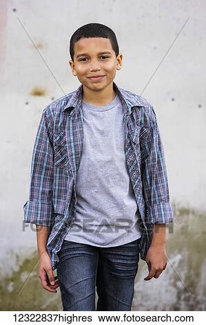 Stock Photograph - Portrait of a young boy walking towards the camera; Oregon, United States of America. Fotosearch