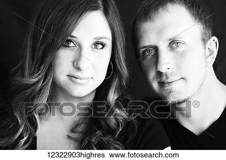 Stock Photograph - Portrait of a young couple against a black background; Oregon, United States of America. Fotosearch