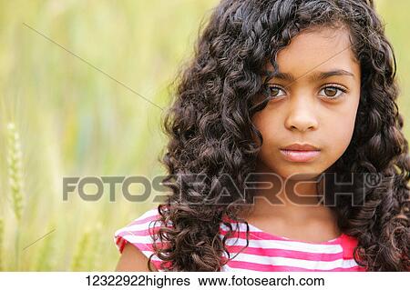 Portrait Of A Young Girl With Dark Curly Hair And Big Brown Eyes Vancouver Washington United States Of America Stock Photograph