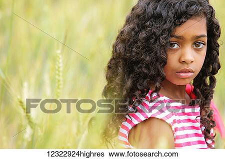 Portrait of a young girl with dark, curly hair and big brown eyes; Vancouver, Washington, United States of America View Large Photo Image Stock Photograph - Portrait of a young girl with dark, curly hair and big brown eyes; Vancouver, Washington, United States of America. Fotosearch