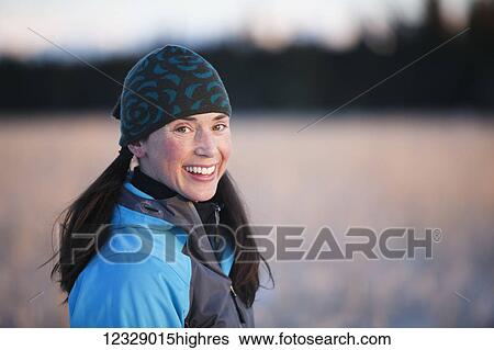 Portrait of a young woman wearing a knit hat and standing in a field; Homer, Alaska, United States of America View Large Photo Image Stock Photograph - Portrait of a young woman wearing a knit hat and standing in a field; Homer, Alaska, United States of America. Fotosearch