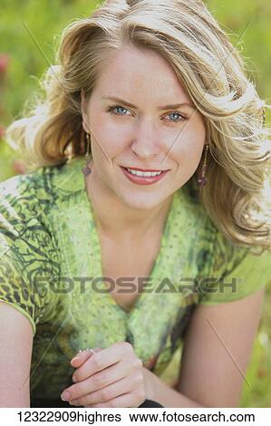 Portrait of a young woman with blond curly hair in a field of flowers; Oregon, United States of America View Large Photo Image Stock Photograph - Portrait of a young woman with blond curly hair in a field of flowers; Oregon, United States of America. Fotosearch