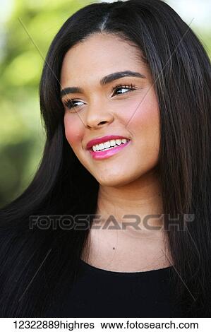 Stock Photograph - Portrait of a young woman with long black hair; Oregon, United States of America. Fotosearch