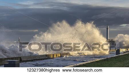 Raging storm on the North East coast of England, waves catching the sunlight; Sunderland, Tyne and Wear, England View Large Photo Image Stock Photograph - Raging storm on the North East coast of England, waves catching the sunlight; Sunderland, Tyne and Wear, England. Fotosearch