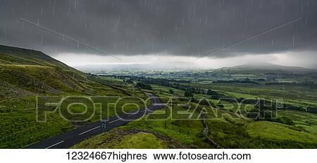 Rain falling from a stormy sky over a lush, green landscape; North Yorkshire, England View Large Photo Image Stock Photograph - Rain falling from a stormy sky over a lush, green landscape; North Yorkshire, England. Fotosearch