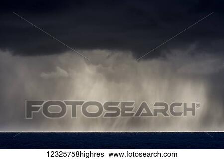 Rain falls over the ocean; Cannon Beach, Oregon, United States of America View Large Photo Image Stock Photograph - Rain falls over the ocean; Cannon Beach, Oregon, United States of America. Fotosearch