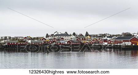 Red buildings along the water's edge under a cloudy sky; Lofoten Islands, Nordland, Norway View Large Photo Image Stock Photograph - Red buildings along the water's edge under a cloudy sky; Lofoten Islands, Nordland, Norway. Fotosearch