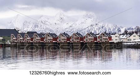 Red buildings along the water's edge with snow covered mountains in the background; Svolvar, Lofoten Islands, Nordland, Norway View Large Photo Image Stock Photograph - Red buildings along the water's edge with snow covered mountains in the background; Svolvar, Lofoten Islands, Nordland, Norway. Fotosearch