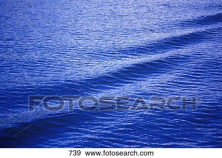 Ripples and waves on dark blue water surface View Large Photo Image Stock Photo - Ripples and waves on dark blue water surface. Fotosearch