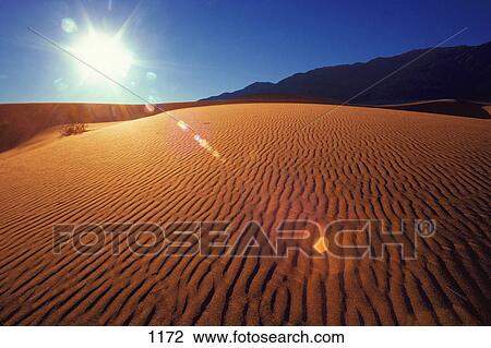 Ripples in desert sand with mountain in background View Large Photo Image Stock Image - Ripples in desert sand with mountain in background. Fotosearch