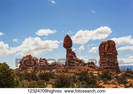 Rugged rock formations and shrubs in the desert, Arches National Park; Arizona, United States of America View Large Photo Image Stock Photograph - Rugged rock formations and shrubs in the desert, Arches National Park; Arizona, United States of America. Fotosearch