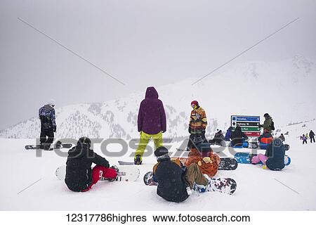 S0wboarders sit in the s0w at a ski resort, Banff National Park; Banff, Alberta, Canada View Large Photo Image Stock Photograph - S0wboarders sit in the s0w at a ski resort, Banff National Park; Banff, Alberta, Canada. Fotosearch