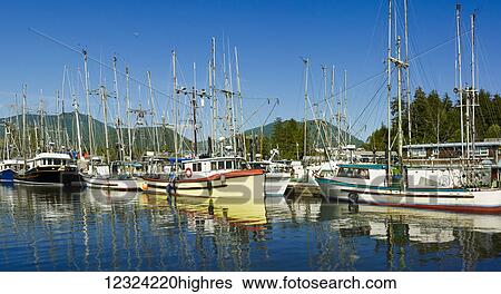 Stock Photograph - Sailboats moored in the tranquil water of Ucluelet harbour; Ucluelet, British Columbia, Canada. Fotosearch