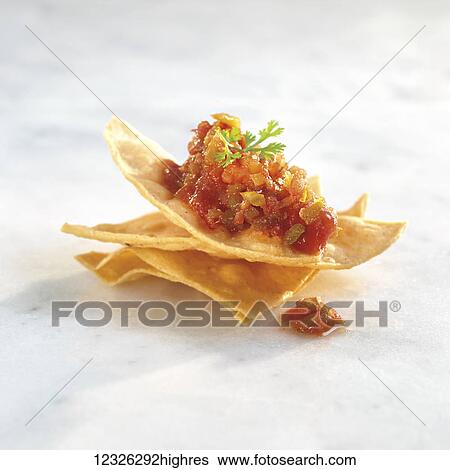 Stock Photograph - Salsa on tortilla chips. Fotosearch