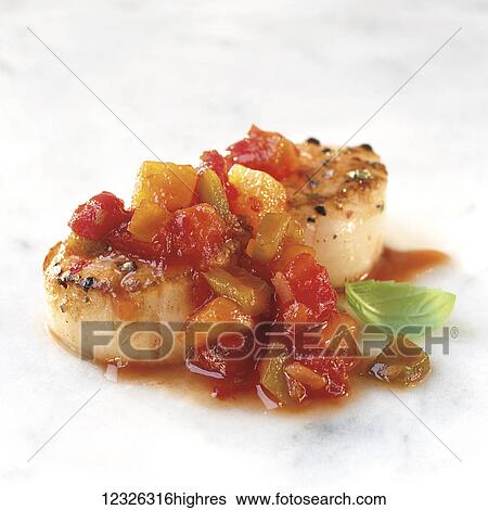 Stock Photograph - Scallops with a fresh salsa on a white background. Fotosearch