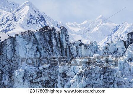 Stock Photograph - Scenic view of a glacial moraine and s0w covered mountains, Glacier Bay National Park, Southeast Alaska, USA. Fotosearch