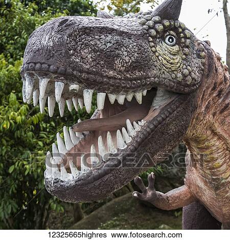 Stock Photograph - Sculpture of a dinosaur with a wide open mouth showing it's teeth; Ko Samui, Chang Wat Surat Thani, Thailand. Fotosearch
