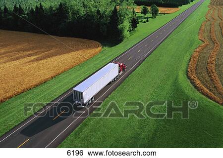 Stock Photograph - Semi truck on small two lane highway. Fotosearch