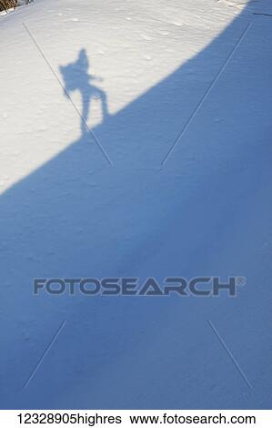 Shadow of a hiker climbing a steep snowy slope; Alaska, United States of America View Large Photo Image Stock Photograph - Shadow of a hiker climbing a steep snowy slope; Alaska, United States of America. Fotosearch