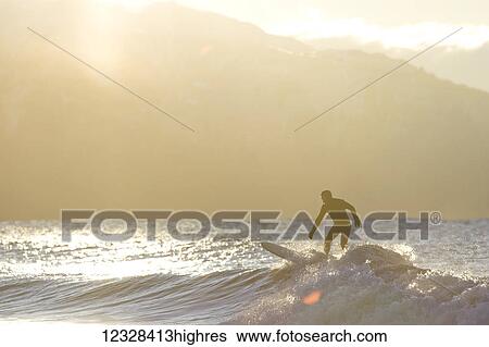 Silhouette of a surfer on a wave in Kachemak Bay; Homer, Alaska, United States of America View Large Photo Image Stock Photograph - Silhouette of a surfer on a wave in Kachemak Bay; Homer, Alaska, United States of America. Fotosearch
