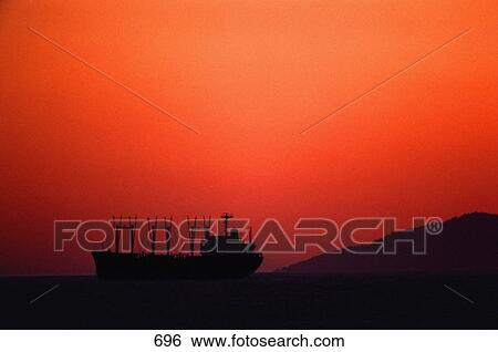 Silhouette of large cargo vessel at dusk View Large Photo Image Stock Photograph - Silhouette of large cargo vessel at dusk. Fotosearch