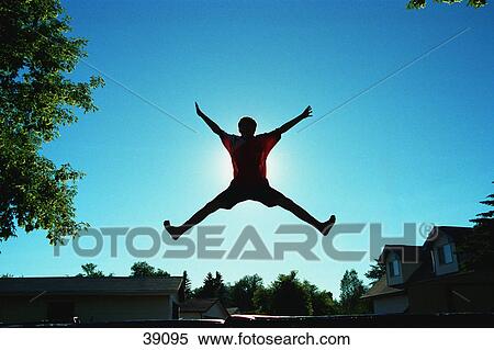 Silhouette of person doing star jump View Large Photo Image Stock Photography - Silhouette of person doing star jump. Fotosearch
