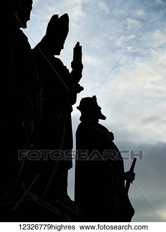 Silhouetted statues of men in a row on Charles Bridge with a cloudy sky in the background; Prague, Czech Republic View Large Photo Image Stock Photograph - Silhouetted statues of men in a row on Charles Bridge with a cloudy sky in the background; Prague, Czech Republic. Fotosearch