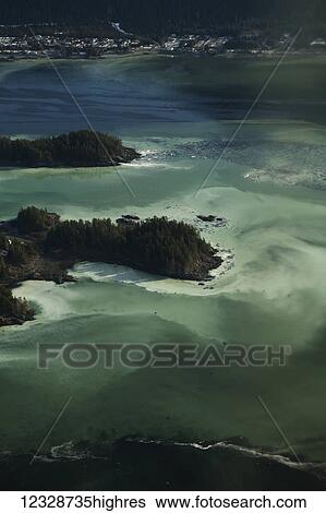 Stock Photograph - Sitka Sound, with cloudy water from herring milt; Alaska, United States of America. Fotosearch