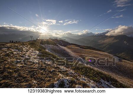 Stock Photograph - Ski lifts and snow capped peaks of the Greater Caucasus Mountain Range; Tetnuldi, Samegrelo-Zemo Svaneti, Georgia. Fotosearch