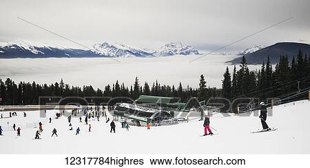 Stock Photograph - Skiers at a ski resort, Banff National Park; Banff, Alberta, Canada. Fotosearch