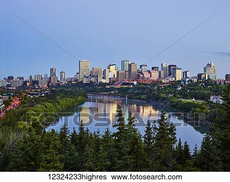 Stock Photograph - Skyline of downtown Edmonton and the North Saskatchewan River under a blue sky; Edmonton, Alberta, Canada. Fotosearch