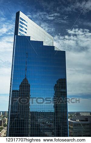 Skyscraper with glass facade reflecting the blue sky and other skyscrapers; Minneapolis, Minnesota, United States of America View Large Photo Image Stock Photograph - Skyscraper with glass facade reflecting the blue sky and other skyscrapers; Minneapolis, Minnesota, United States of America. Fotosearch