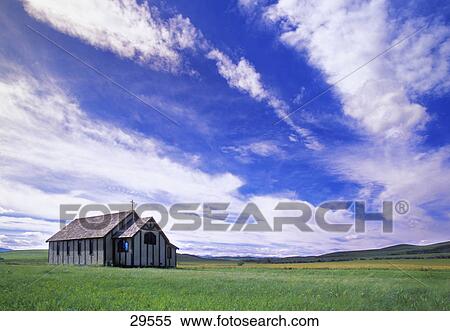 Stock Photography - Small country church in grass field. Fotosearch