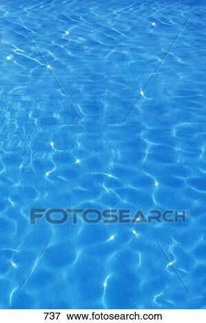 Stock Photo - Small smooth ripples on blue water surface. Fotosearch