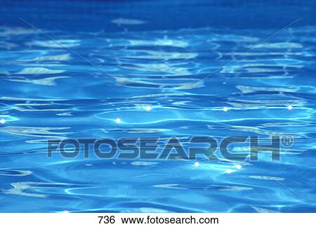 Stock Photograph - Small smooth ripples on blue water surface. Fotosearch