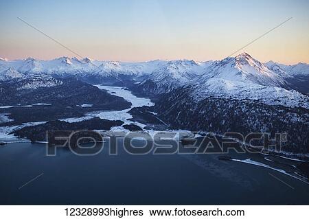 Stock Photograph - Snow covered Kenai mountains in winter, Kachemak Bay State Park; Alaska, United States of America. Fotosearch