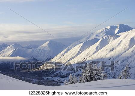 Snow covered mountain range in winter; Alaska, United States of America View Large Photo Image Stock Photograph - Snow covered mountain range in winter; Alaska, United States of America. Fotosearch