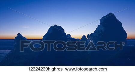 Stock Photograph - Snow covered peaked rocks at Pigeon Lake in winter; Alberta, Canada. Fotosearch