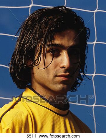 Stock Image - Soccer goalkeeper wearing yellow shirt. Fotosearch